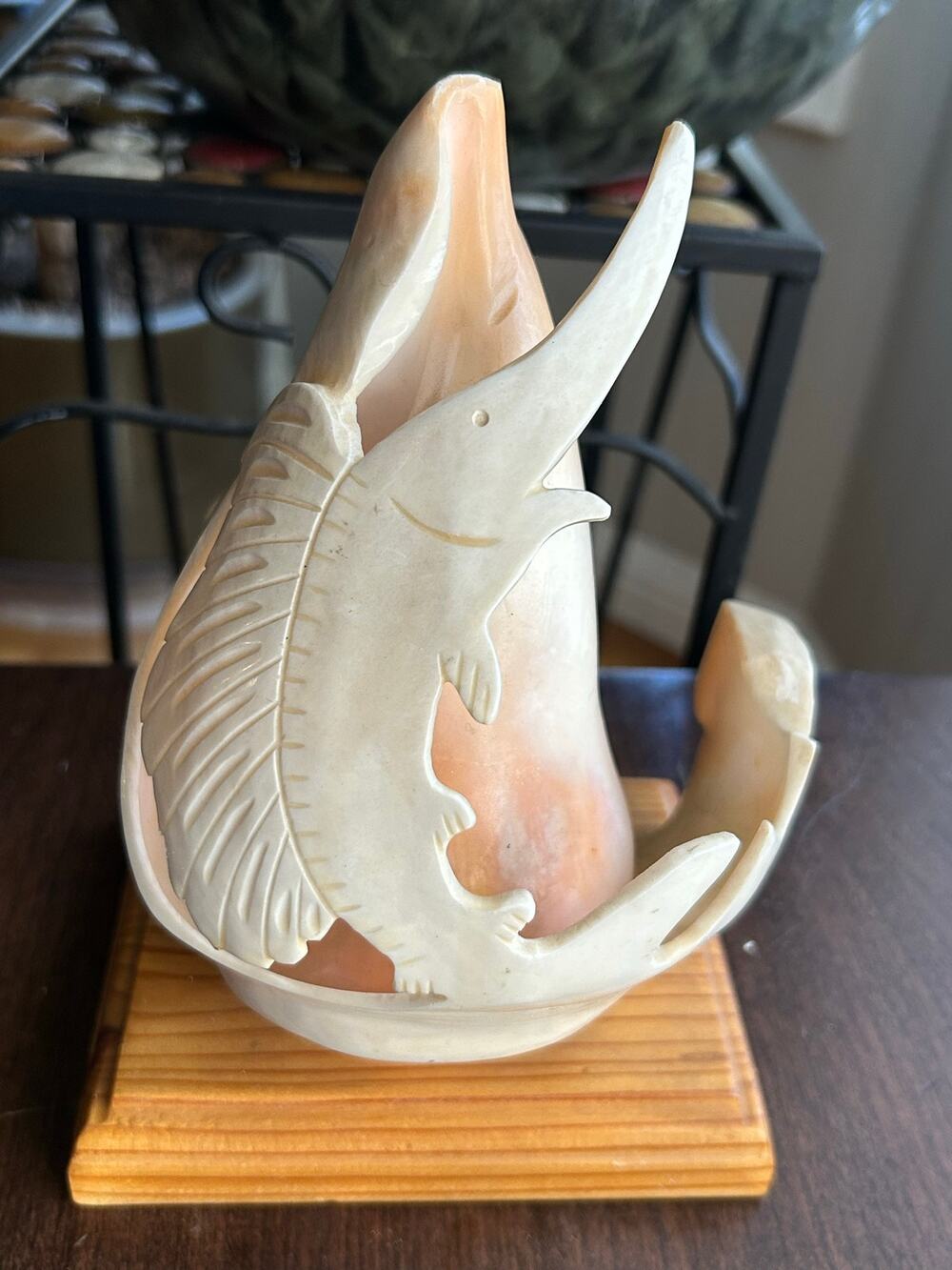 Carved shell sculpture swordfish marlin mounted on a wooden base